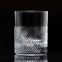 Load image into Gallery viewer, Crystal glass with intricate design on a black background