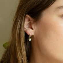 Load image into Gallery viewer, Woman wearing a small hoop earring with a pearl charm