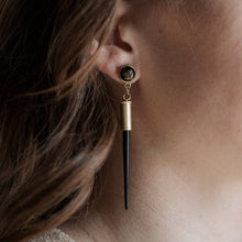 Load image into Gallery viewer, Close-up of an earring with a black and gold design on a person's ear.