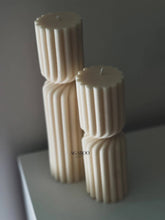 Load image into Gallery viewer, Three cylindrical candles with textured design on a gray surface and background.