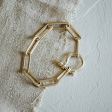 Load image into Gallery viewer, Gold chain bracelet on a textured fabric background