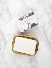 Load image into Gallery viewer, Bar of soap in a gold dish with a packaging box on a marble surface