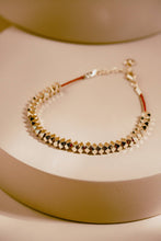 Load image into Gallery viewer, Bracelet with geometric design on a beige background