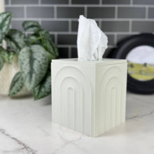 Load image into Gallery viewer, White tissue box with tissues on a marble surface, plant and blurred background