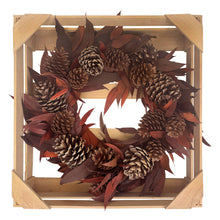 Load image into Gallery viewer, Decorative wreath with pinecones and leaves in a wooden frame on a white background
