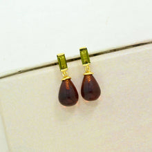 Load image into Gallery viewer, Pair of earrings with brown teardrop-shaped stones and green accents on a white background