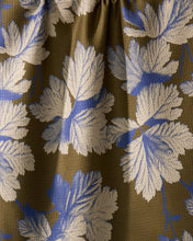 Load image into Gallery viewer, Close-up of fabric with floral pattern on brown background