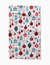 Load image into Gallery viewer, Tea towel with Christmas-themed pattern featuring ornaments and trees on a white background