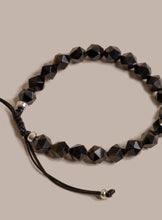 Load image into Gallery viewer, Black beaded bracelet on a beige background