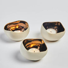 Load image into Gallery viewer, A set of three ceramic candle holders with a bronze interior and a muted beige exterior finish