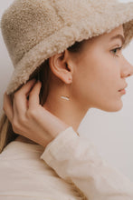 Load image into Gallery viewer, Woman wearing a beige fur hat and light-colored coat, with a neutral background