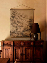 Load image into Gallery viewer, Wooden cabinet with a lamp and wall art in a warm-toned room