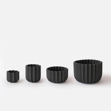 Load image into Gallery viewer, Set of four black textured planters on a white background