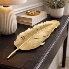 Load image into Gallery viewer, Gold leaf decorative item on a wooden surface with a lamp and books in the background.
