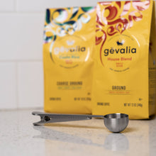 Load image into Gallery viewer, Gevalia coffee package with a metal scoop on a light surface