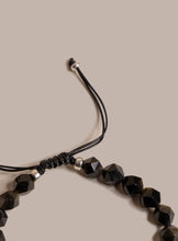 Load image into Gallery viewer, Black beaded bracelet on a beige background