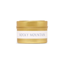 Load image into Gallery viewer, A gold-colored jar of Rocky Mountain Travel candle with a label that has 'ROCKY MOUNTAIN' written on it.