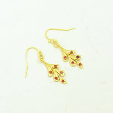 Load image into Gallery viewer, Gold earrings with red gemstones on a white background