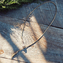 Load image into Gallery viewer, Solid brass serpant lariat necklace on a wooden background