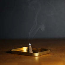 Load image into Gallery viewer, Incense cone burning in a gold holder with a dark background