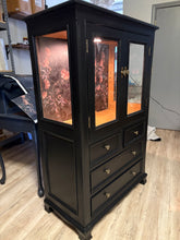 Load image into Gallery viewer, Black wooden cabinet with glass panels on a wooden floor