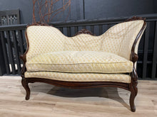 Load image into Gallery viewer, Vintage-style sofa with wooden frame and patterned fabric on a wooden deck.