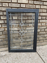 Load image into Gallery viewer, Decorative glass panel with black frame on a textured pavement background