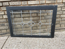 Load image into Gallery viewer, Decorative glass panel with black frame on a brick wall background