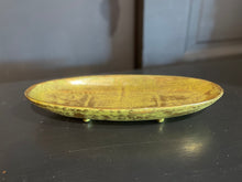 Load image into Gallery viewer, Vintage ceramic plate with a textured surface on a dark surface