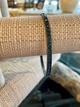 Load image into Gallery viewer, Bangle with blue stones on a textured surface