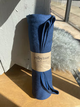 Load image into Gallery viewer, Blue scarf with a visible brand label on a wooden surface