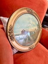 Load image into Gallery viewer, Vintage oval photo frame with a small picture of a house on a red cushion