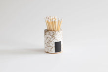 Load image into Gallery viewer, Cylindrical container with a black label holding wooden sticks on a light gray background