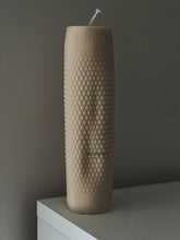 Load image into Gallery viewer, Textured beige candle on a white surface with a dark background