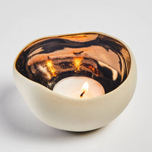 Load image into Gallery viewer, Ceramic candle holder with a bronze interior and a muted beige exterior finish
