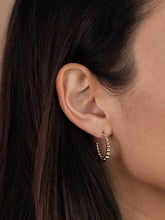 Load image into Gallery viewer, Close-up of an ear wearing a gold hoop earring with dark hair.