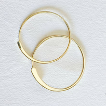 Load image into Gallery viewer, Gold hoop bracelets on a textured white background