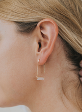 Load image into Gallery viewer, Gold hoop earring worn by a person with blonde hair.