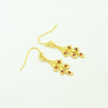 Load image into Gallery viewer, Gold earrings with red gemstones on a white background