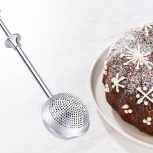 Load image into Gallery viewer, Metallic kitchen tool next to a cake with white frosting on a light background