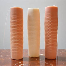 Load image into Gallery viewer, Three textured candles of different colors on a reflective surface with a neutral background