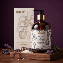 Load image into Gallery viewer, Formulary Sea Salt & Lavender hand wash bottle and packaging on a wooden tray with lavender flowers.