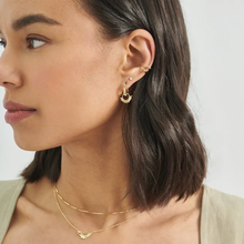 Load image into Gallery viewer, Close-up of a woman wearing gold earrings and necklaces against a neutral background