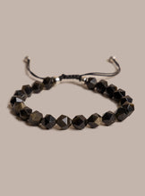 Load image into Gallery viewer, Black beaded bracelet on a beige background