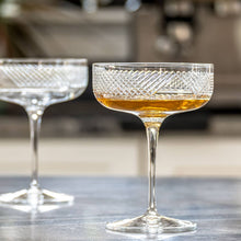 Load image into Gallery viewer, Two crystal glasses with a patterned base on a blurred background