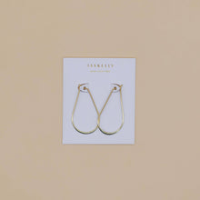 Load image into Gallery viewer, Gold hoop earrings on a branded card against a beige background