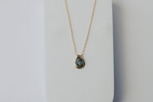 Load image into Gallery viewer, Necklace with a pendant on a light gray background