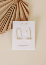 Load image into Gallery viewer, Gold earrings on a Jaxkelly branded card with a beige background