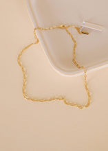 Load image into Gallery viewer, Gold chain necklace on a beige surface