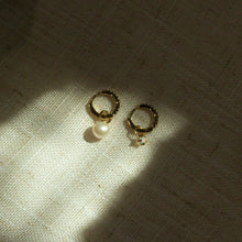 Load image into Gallery viewer, two small hoop earring on a textured background